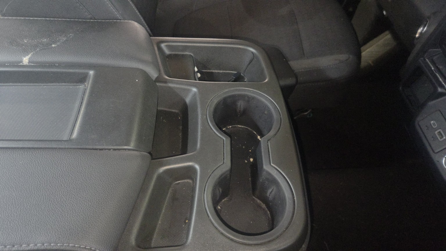Dirty Chevrolet center console before detailing